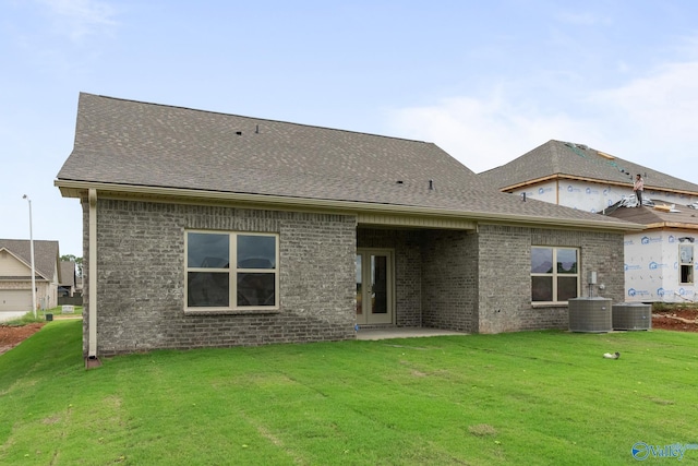 416 Tracer St, Huntsville, AL 35811 - rear view of property with a yard, brick siding, a patio area, and central AC unit