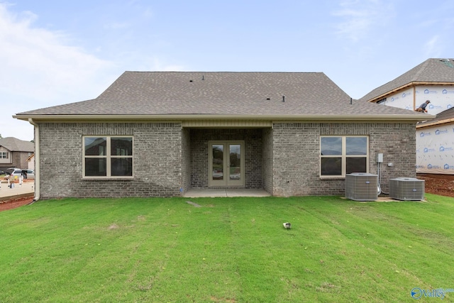 416 Tracer St, Huntsville, AL 35811 - back of property featuring a shingled roof, french doors, brick siding, and a lawn
