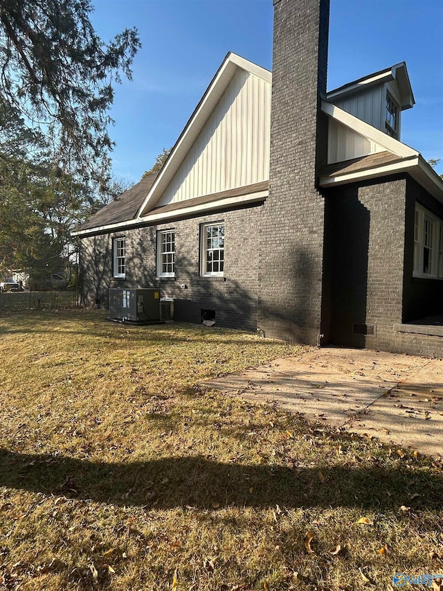 view of home's exterior featuring cooling unit and a yard