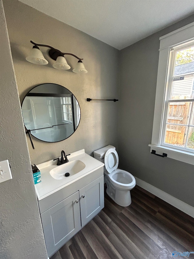 bathroom featuring hardwood / wood-style floors, vanity, and toilet