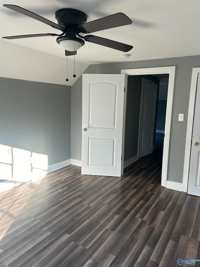 interior space featuring ceiling fan, lofted ceiling, and dark hardwood / wood-style floors