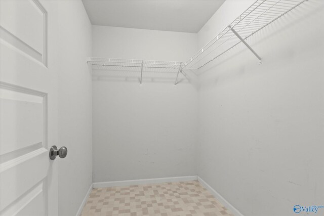 walk in closet featuring light tile patterned floors