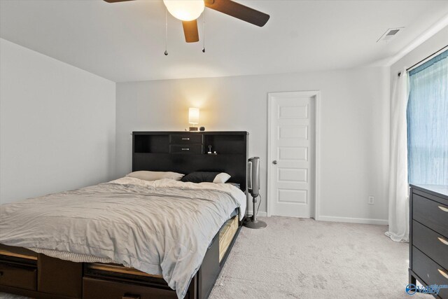 bedroom featuring light colored carpet and ceiling fan