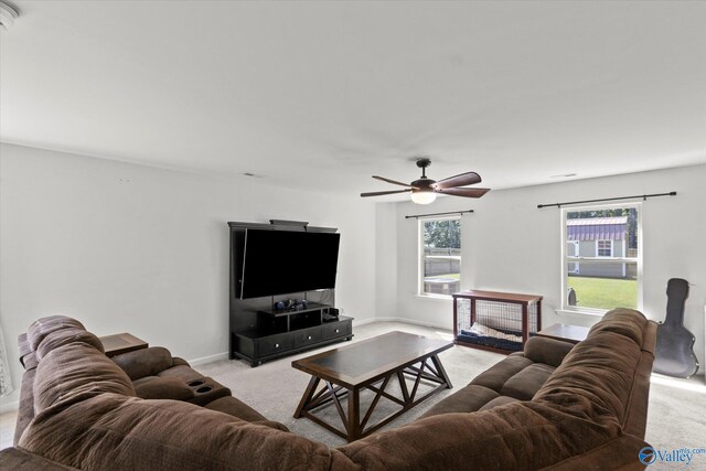 carpeted living room with ceiling fan