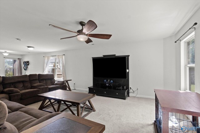 carpeted living room with ceiling fan and a healthy amount of sunlight