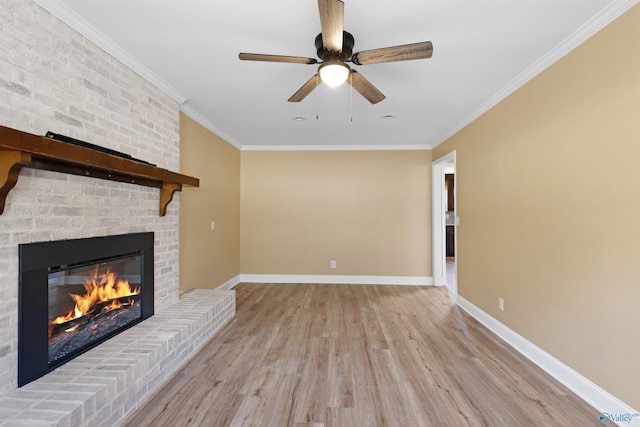 unfurnished living room featuring ceiling fan, a brick fireplace, ornamental molding, and light hardwood / wood-style flooring