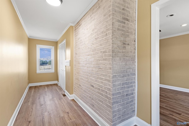 corridor featuring crown molding and light hardwood / wood-style flooring