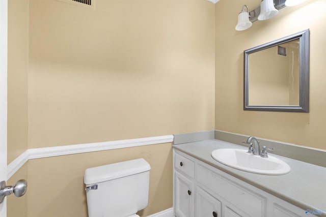 bathroom with toilet and vanity