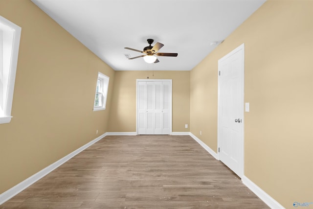 unfurnished bedroom with ceiling fan and light hardwood / wood-style floors