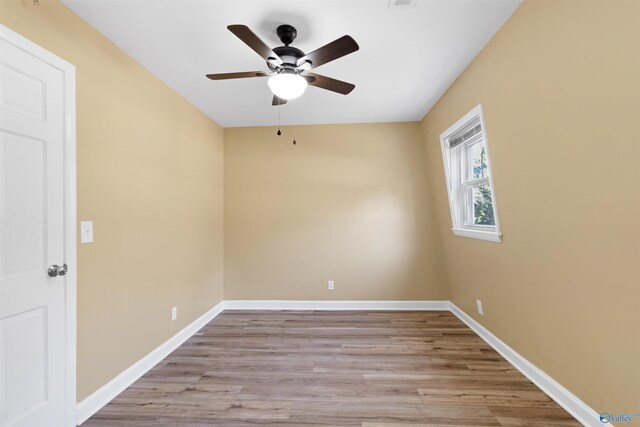 spare room featuring light wood-type flooring and ceiling fan