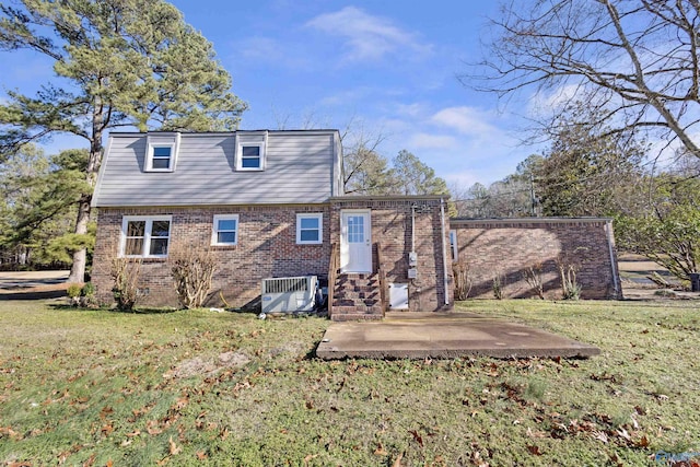 rear view of house featuring cooling unit, a yard, and a patio