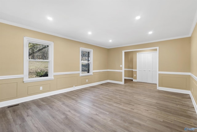 unfurnished room with light hardwood / wood-style flooring and ornamental molding