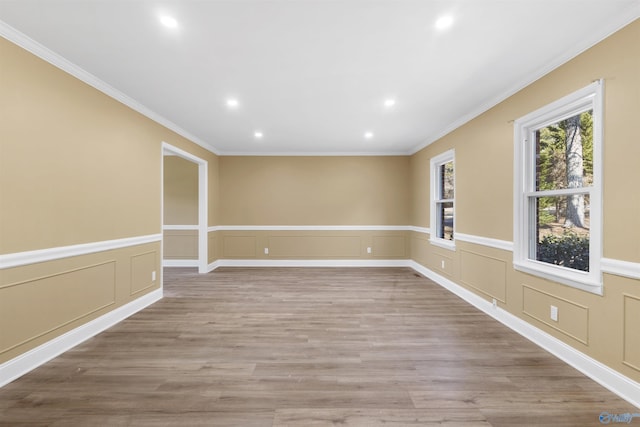 unfurnished room with light wood-type flooring and crown molding