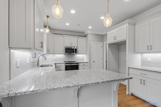 kitchen with range, sink, light stone countertops, light hardwood / wood-style floors, and backsplash