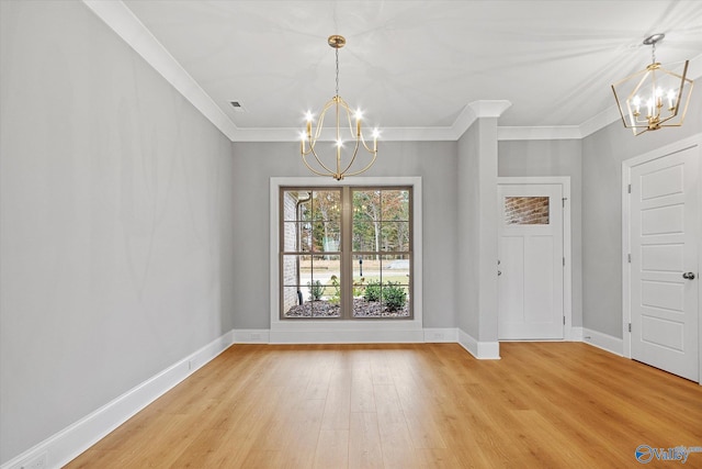 unfurnished dining area with light hardwood / wood-style floors, a chandelier, and ornamental molding