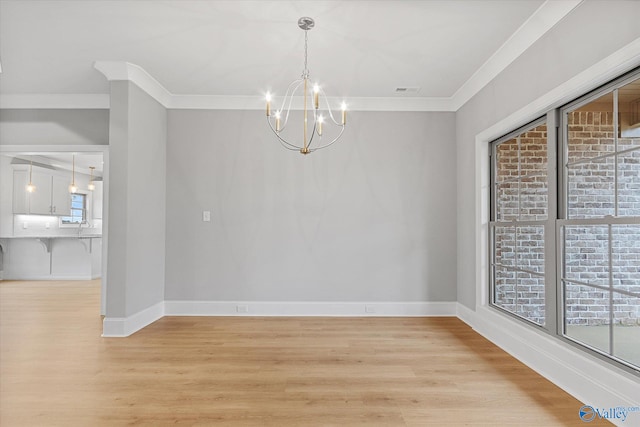 unfurnished dining area featuring a healthy amount of sunlight, light wood-type flooring, and a chandelier