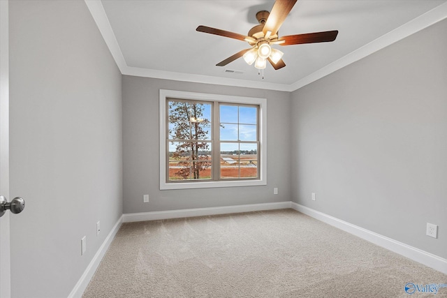 spare room featuring crown molding, carpet, and ceiling fan