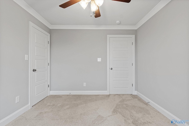 carpeted empty room with crown molding and ceiling fan