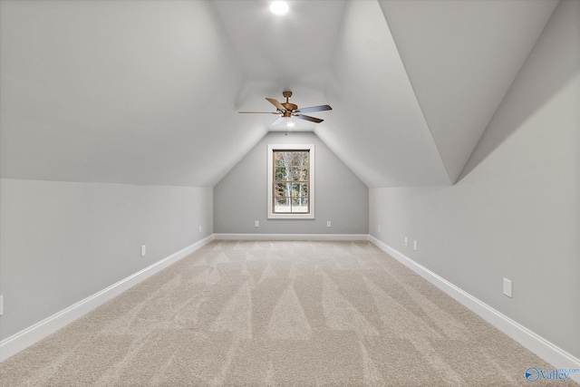 bonus room featuring ceiling fan, lofted ceiling, and light colored carpet