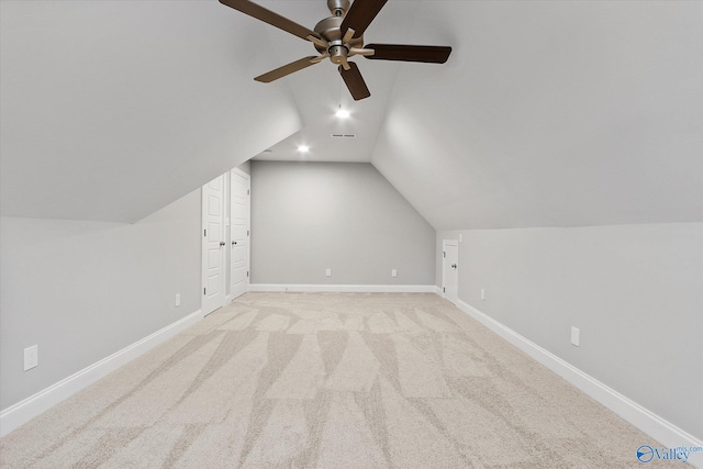 additional living space featuring lofted ceiling, light colored carpet, and ceiling fan