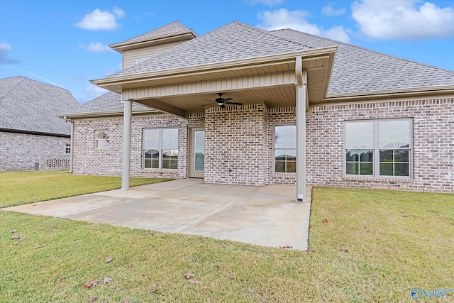 rear view of house with a patio area, a yard, and ceiling fan