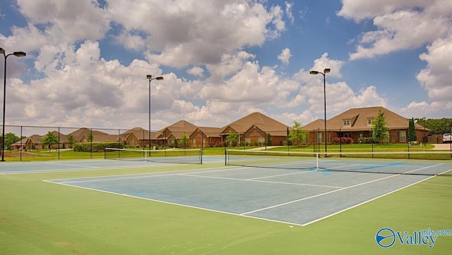 view of tennis court featuring basketball hoop