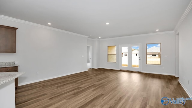 unfurnished living room featuring dark wood-type flooring and ornamental molding