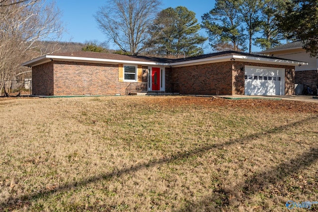 ranch-style house featuring a garage and a front yard