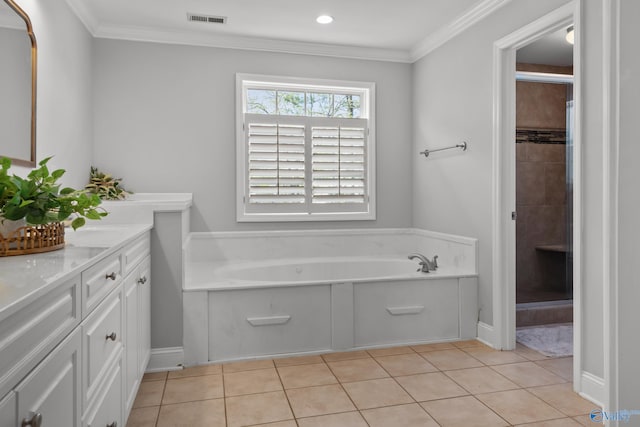 bathroom with visible vents, a bath, ornamental molding, double vanity, and tile patterned flooring