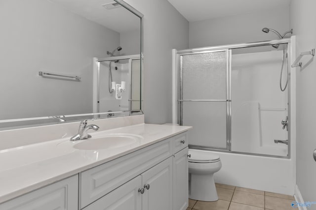 full bathroom with vanity, tile patterned flooring, visible vents, toilet, and combined bath / shower with glass door
