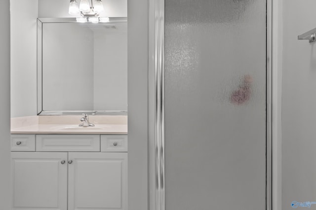 bathroom featuring a shower stall and vanity