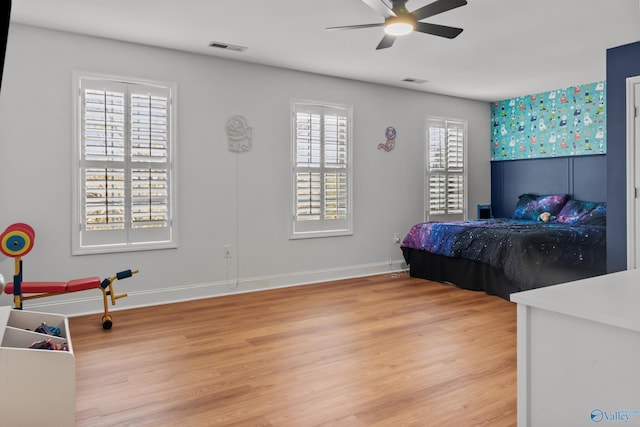 bedroom featuring visible vents, baseboards, and light wood finished floors