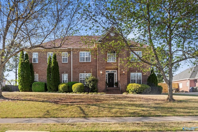 view of front of home with a front lawn and brick siding