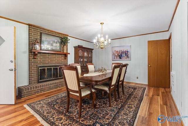 259 Old Big Cove Rd, Brownsboro, AL 35741 - dining room featuring crown molding, a chandelier, wood finished floors, and a fireplace