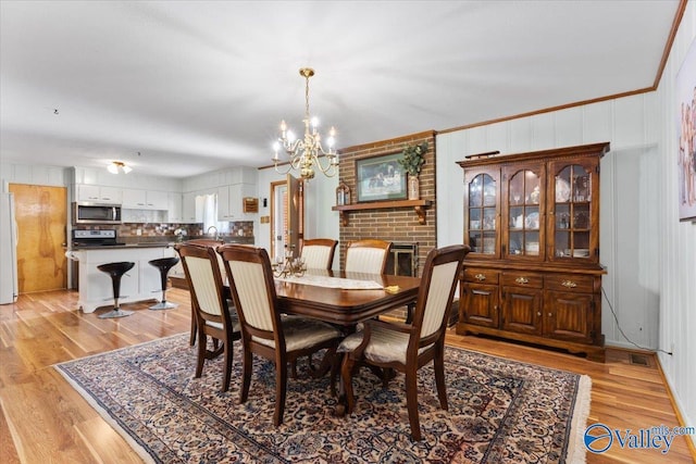 259 Old Big Cove Rd, Brownsboro, AL 35741 - dining area featuring a chandelier and light wood-style flooring