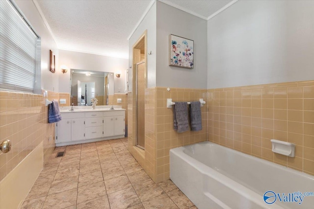 259 Old Big Cove Rd, Brownsboro, AL 35741 - bathroom featuring tile walls, double vanity, a garden tub, a stall shower, and wainscoting