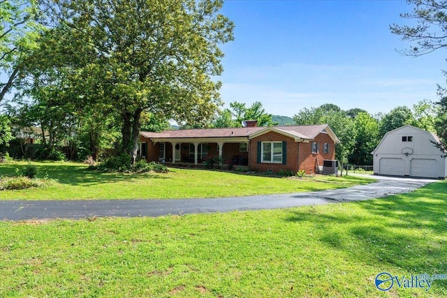 259 Old Big Cove Rd, Brownsboro, AL 35741 - ranch-style home with an outdoor structure, a garage, brick siding, and a front lawn