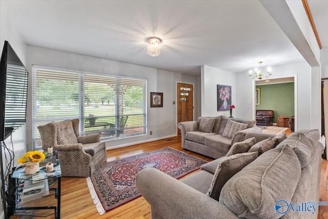 259 Old Big Cove Rd, Brownsboro, AL 35741 - living area featuring a chandelier, wood finished floors, and baseboards