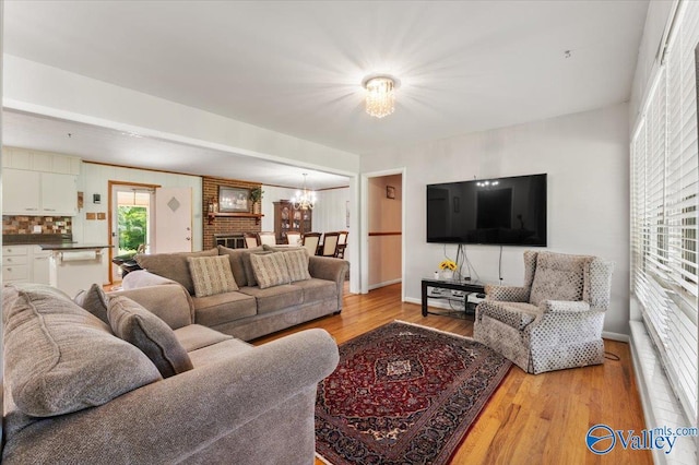 259 Old Big Cove Rd, Brownsboro, AL 35741 - living room with a chandelier, light wood-style floors, and baseboards
