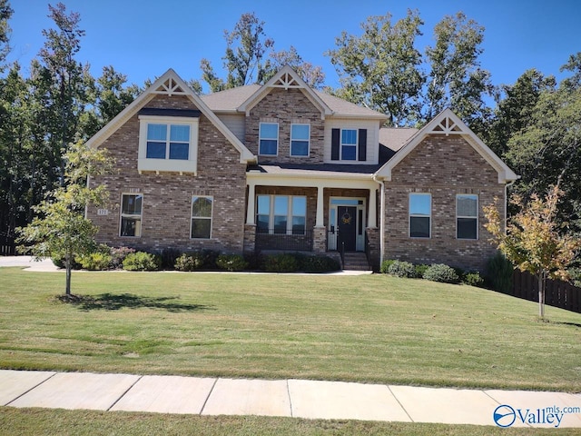 craftsman-style house featuring a front lawn and brick siding