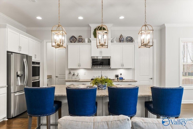 kitchen featuring dark wood-style floors, appliances with stainless steel finishes, and crown molding