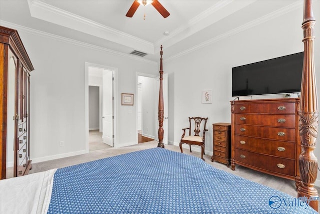 bedroom with light carpet, baseboards, visible vents, ornamental molding, and a tray ceiling