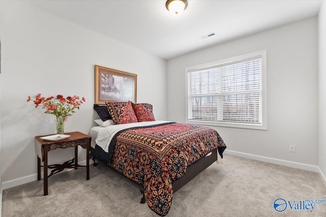 carpeted bedroom featuring visible vents and baseboards