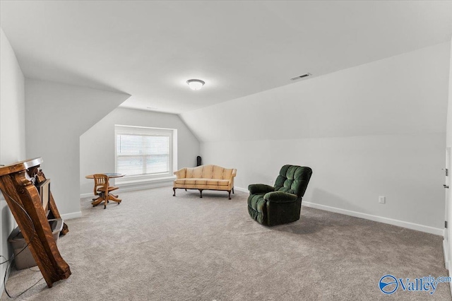 sitting room with carpet floors, baseboards, visible vents, and vaulted ceiling