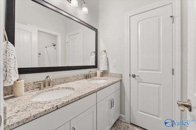 bathroom featuring a sink and double vanity