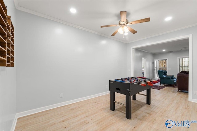 recreation room featuring light wood-style flooring, baseboards, crown molding, and recessed lighting