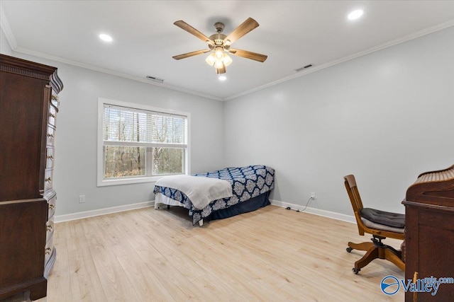 bedroom featuring baseboards, visible vents, wood finished floors, and ornamental molding