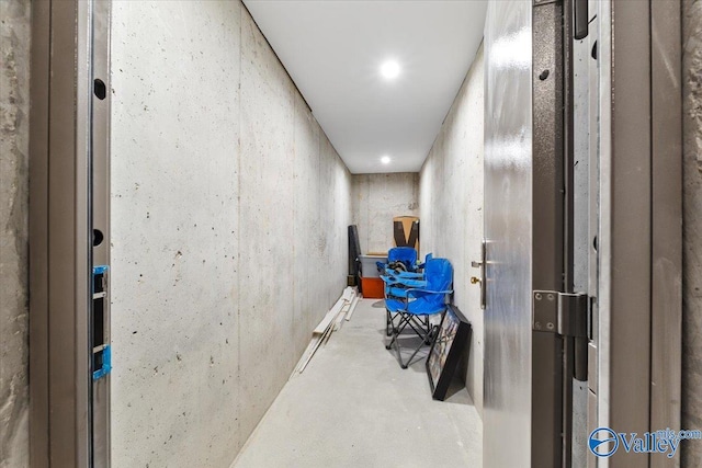 hall with concrete flooring