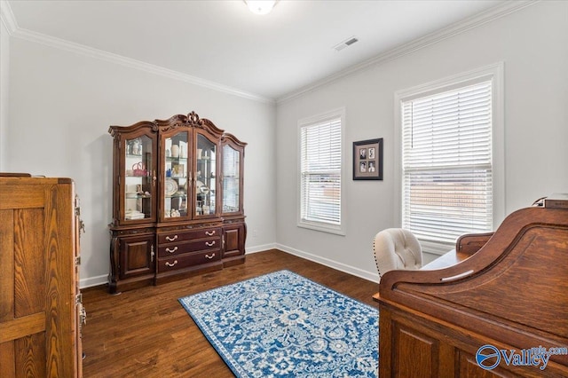 office area with crown molding, dark wood-style flooring, visible vents, and baseboards