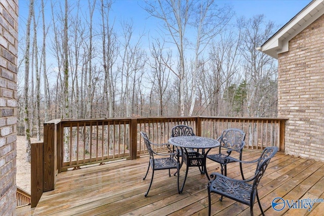 wooden deck featuring outdoor dining space